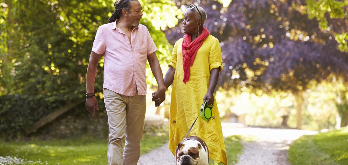 Man and Woman Walking Dog