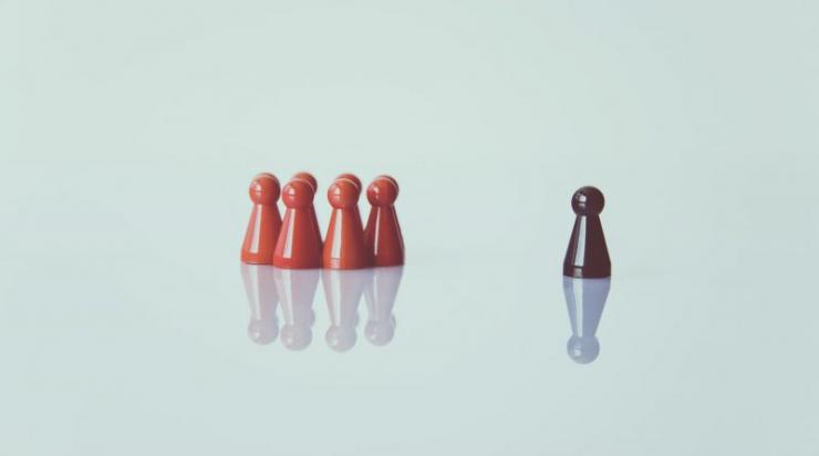 Two different colored sets of chess pieces illustrating racism.